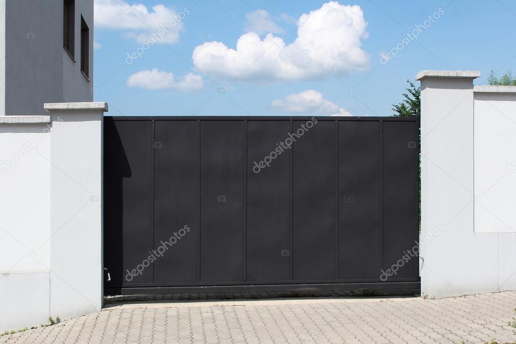 Modern black gate and sky in the background