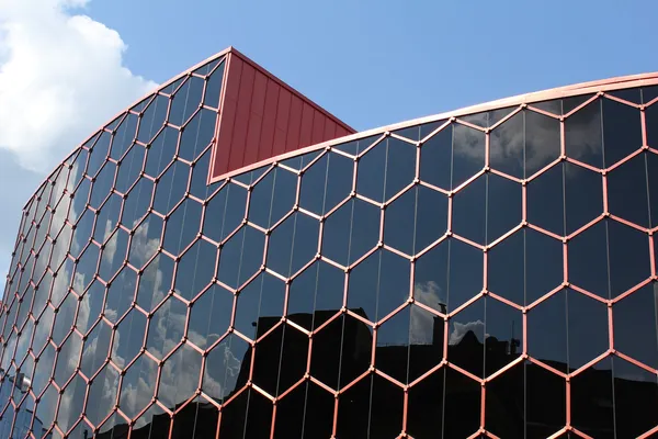 Modern glass building with sky in the background