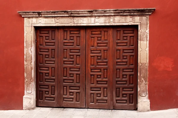 빨간 벽에 나무 장식 게이트입니다. 멕시코 건축 — 스톡 사진