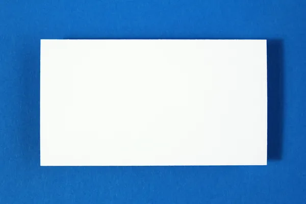 Blank business card on blue paper background — Stock Photo, Image