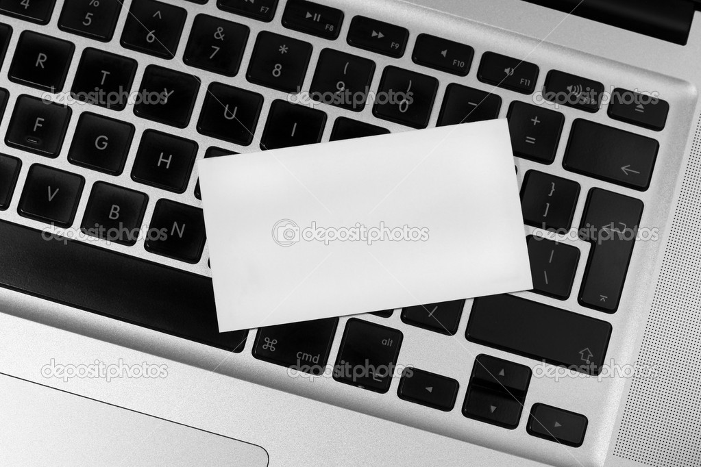 Blank business card on silver laptop