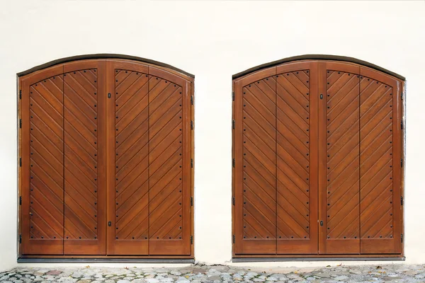 Two wooden entrance gate on white wall