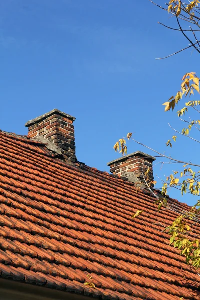 Red tile roof and two chimneys — Stock Photo, Image