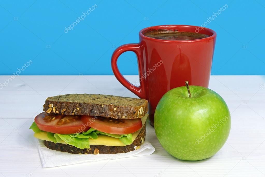 Healthy lunch- sandwich, green apple and coffe in red cup