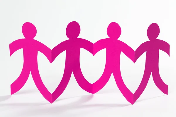 Pink paper people in a row — Stock Photo, Image