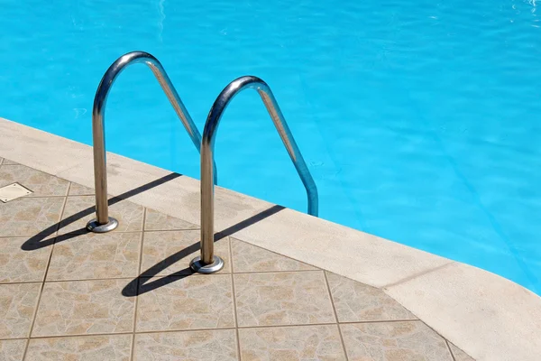 Escaliers de garde-corps dans la piscine bleue — Photo