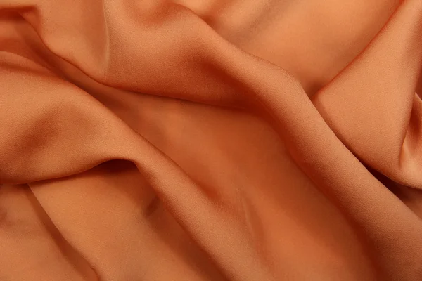 Fond en tissu soyeux orange — Photo