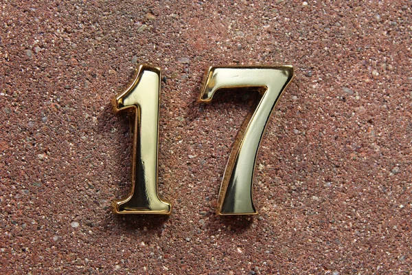 Number seventeen on concrete wall — Stock Photo, Image