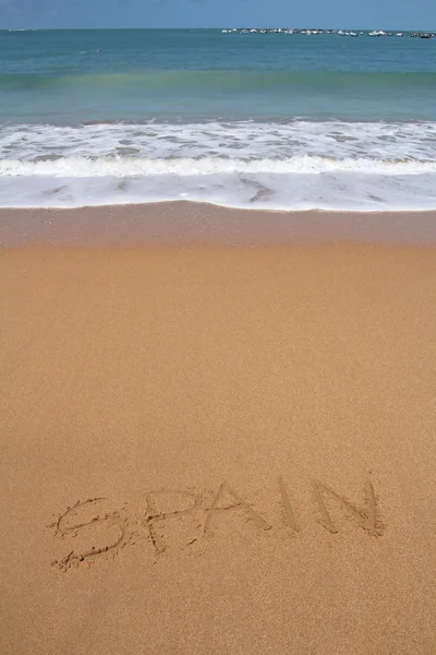 Hermosa playa con palabra de España escrita en arena —  Fotos de Stock