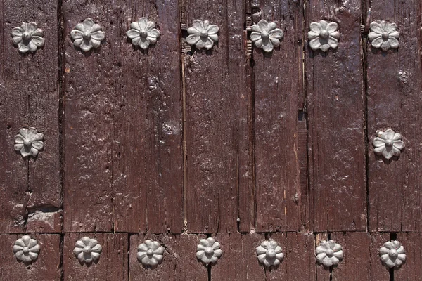 Wooden background with metal rivets flowers shaped — Stock Photo, Image