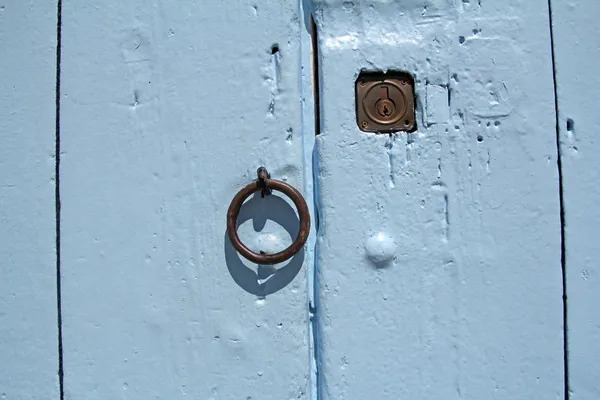 Closeup of blue wooden door with lock and knocker — Stock Photo, Image