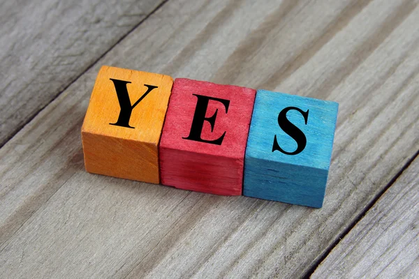 Yes word on wooden colorful cubes — Stock Photo, Image