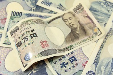 Selective focus on heap of japanese yen banknotes clipart