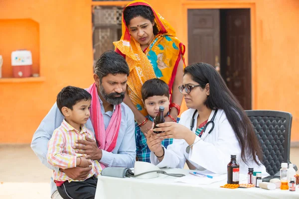Young Indian Female Doctor Rural Family Give Medicine Outdoor Village Stock Picture