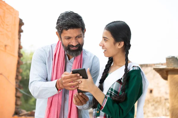 Happy Indian Father Daughter Wearing Traditional Cloths Using Smart Phone Royalty Free Stock Images
