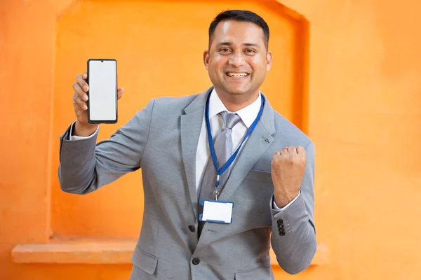 Excited Young Indian Man Wearing Suit Card Pointing Blank Phone Stock Picture