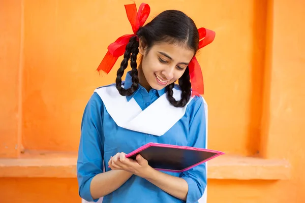 Young Beautiful Happy Indian School Girl Write Slate Orange Background Royalty Free Stock Photos