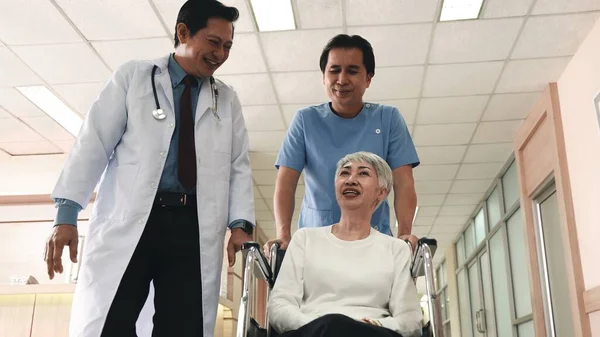 Doctor Talking Elderly Woman Patient Wheelchair Nurse Man Pushing Forward — Stock Photo, Image