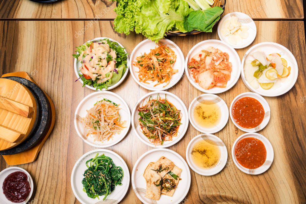 Spicy Kimchi group. Korean pickle or Pickled radish vegetables and seasoning on bowl on wood table background, Japanese food