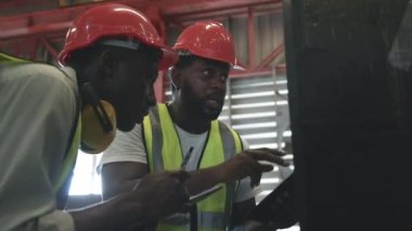 Metal levha fabrikası deposuna sevkiyattan önce iki mühendis Afrikalı siyah işaretli teftiş, fiziksel envanter sayımı, hisse senedi endüstrisini kontrol.