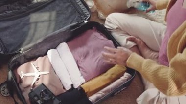 Preparing for travel in new normal. Woman packing clothes in luggage for new journey, Preparation travel suitcase at home, Travel vacation traveling after quarantine coronavirus pandemic concept