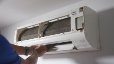 Technician male disassembling air conditioner and preparing it for wash cleaning, The man cleaning and washing maintenance, worker to service cleaning and repair, dust and dirt for healthy living