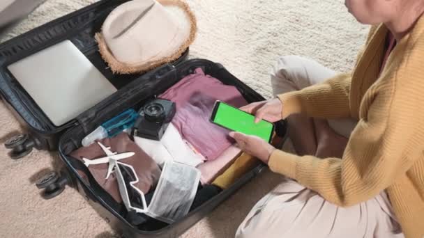 Woman Using Smartphone Blank Green Screen Packing Suitcase Bag Travel — Wideo stockowe