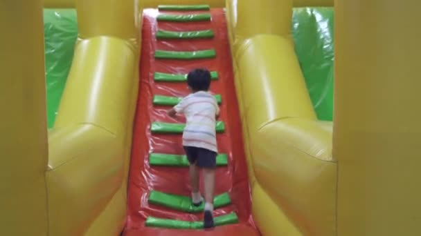 Happy Asian Child Boy Having Fun Inflatable Castle Slider Excited — Stock Video