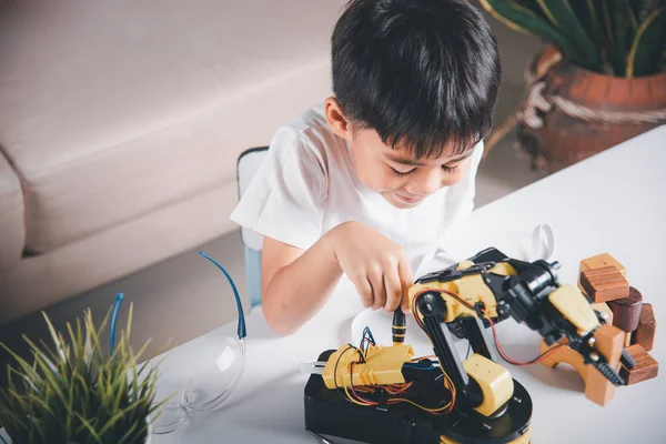 Premium Photo  Asian little boy programming code to robot machine