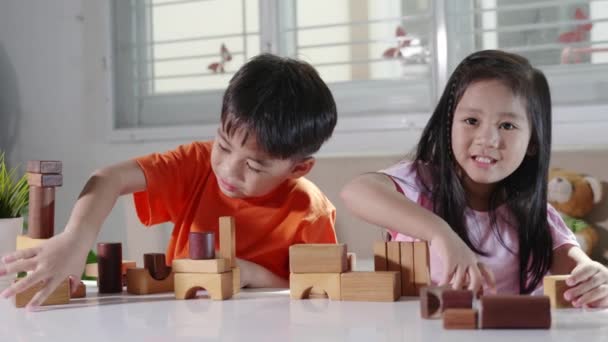 Happy little kids play wood block stacking board game at home, Children boy and girl playing with constructor wooden block, childhood activities learning creative, toys for preschool and kindergarten