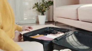 Preparing for travel in new normal. Woman packing clothes in luggage for new journey, Preparation travel suitcase at home, Travel vacation traveling after quarantine coronavirus pandemic concept