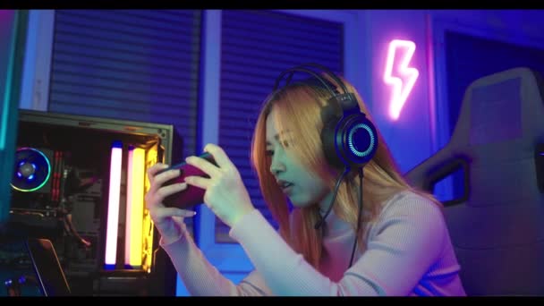 Game Angry Asian Gamer Wearing Gaming Headphones Playing Joystick Console — Stockvideo
