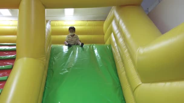 Happy Asian Child Boy Having Fun Inflatable Castle Slider Excited — Stock Video