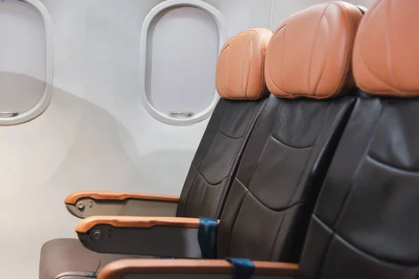 Empty aircraft seats and windows, passenger seat interior airplane, Chair on plane, cabin with modern leather chair, travel and airline business conept