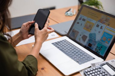 Asian young woman pay for goods digital payment success on smartphone, Smile female buy product on laptop computer she pay money by mobile phone, Easy E-commerce shopping online, lifestyles technology