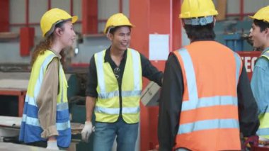 Break time. Happy engineer team talking together in roof steel metal manufacturing factory industry, engineering worker group standing meeting discussing, teamwork concept