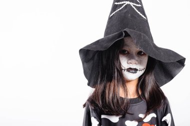 Halloween Kid. Portrait of Asian little kid girl wearing witch costume studio shot isolated white background, Child woman horror face painting make up for scary, Happy halloween day concept