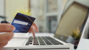 Female register via credit cards on computer make electronic payment security online, Woman hands holding credit card and using laptop with product purchase at home, Internet online shopping concept