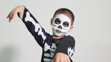 Halloween Kid. Portrait of Asian little kid boy wearing skeleton costume studio shot isolated white background, Child man horror face painting make up for scary, Happy halloween day concept