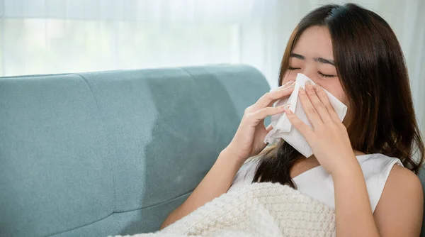 Ill Asian Young Woman Cold Covered Blanket Sitting Sofa Sneeze — 图库照片