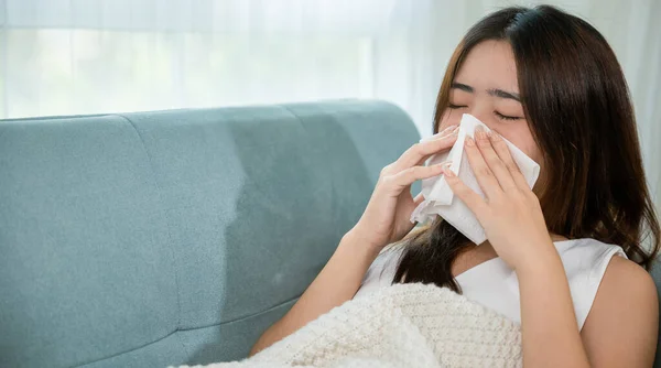 Ill Asian Young Woman Cold Covered Blanket Sitting Sofa Sneeze — Fotografia de Stock