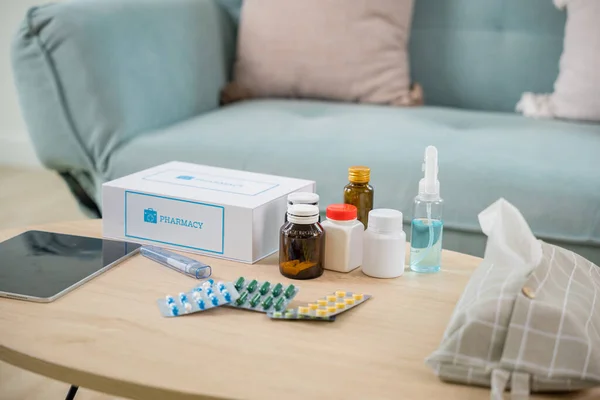 Home medicine with medicine package box free first aid kit with pills from pharmacy hospital delivery service at home on table in living room,  online purchase delivery of medicines to your home