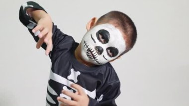 Halloween Kid. Child man horror face painting make up for ghost scary, Portrait of Asian little kid boy wearing skeleton costume studio shot isolated white background, Happy halloween day concept