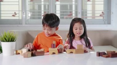 Children boy and girl playing with constructor wooden block building, Happy little kids play wood block stacking board game at home, activities learning creative, toys for preschool and kindergarten