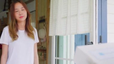 Sick Asian young woman receive medication first aid pharmacy box from hospital delivery service, delivery man give medicine drug to patient female at home, healthcare medicine online concept