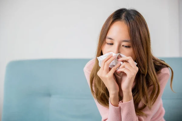 Ill Asian Young Woman Cold Covered Blanket Sitting Sofa Sneeze — Fotografia de Stock