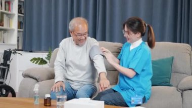 Asian nurse visit patient senior man at home she measuring arterial blood pressure on arm in living room, Doctor woman examine do checking old man client heart rate with pulsimeter monitor, Healthcare