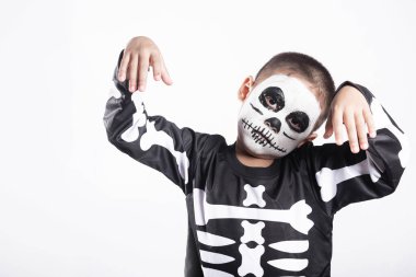 Halloween Kid. Portrait of Asian little kid boy wearing skeleton costume studio shot isolated white background, Child man horror face painting make up for scary, Happy halloween day concept