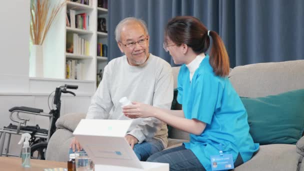 Asian Nurse Physician Explaining Prescription Medicine Attentive Senior Man Home — Stock Video