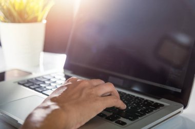 Web application development. programmer woman writing program code sitting at workplace in office, software developer hands coding HTML programming with laptop computer, IT start up concept, back view